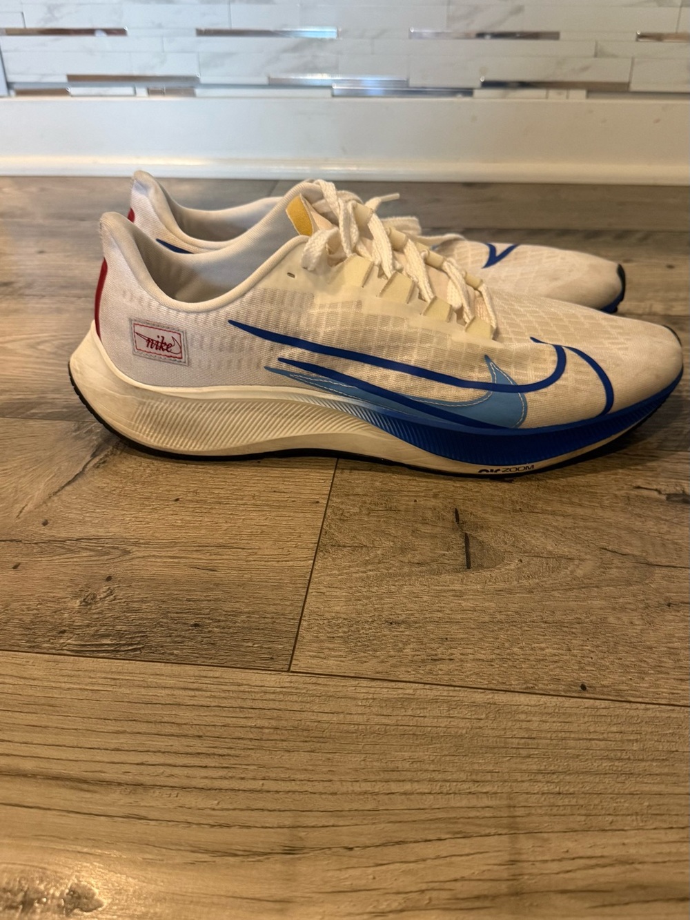 Nike Men’s White/Blue Athletic Running Shoes with Red Heel Accent
